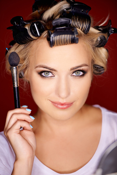 Beauty portrait of a blond wearing curlers - Photo, Image