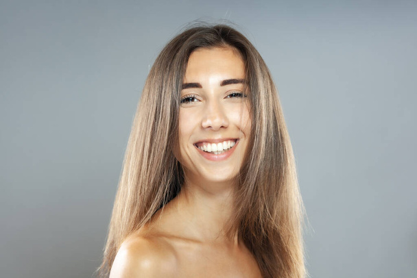 Beautiful brunette girl studio portrait. Smiling face expression. - Foto, Imagen