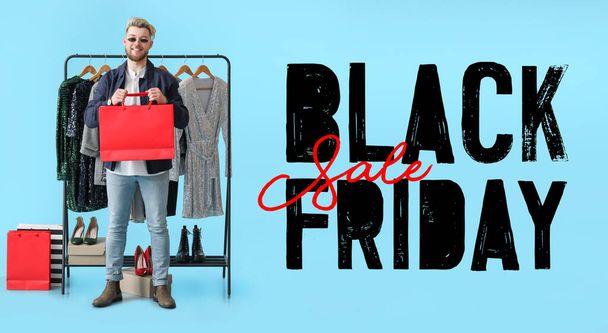 Stylish man with trendy clothes and text BLACK FRIDAY SALE on blue background - 写真・画像