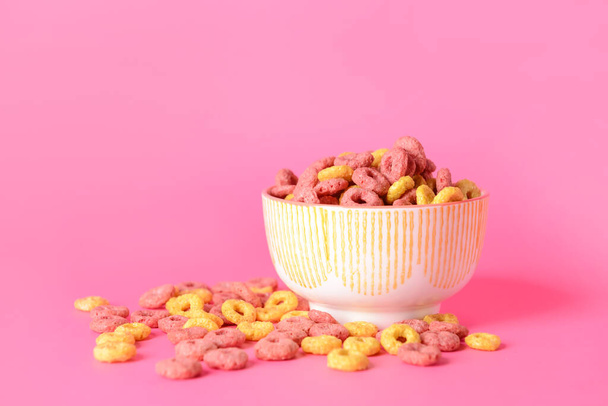 Bol avec des flocons de maïs croquants anneaux sur fond de couleur - Photo, image