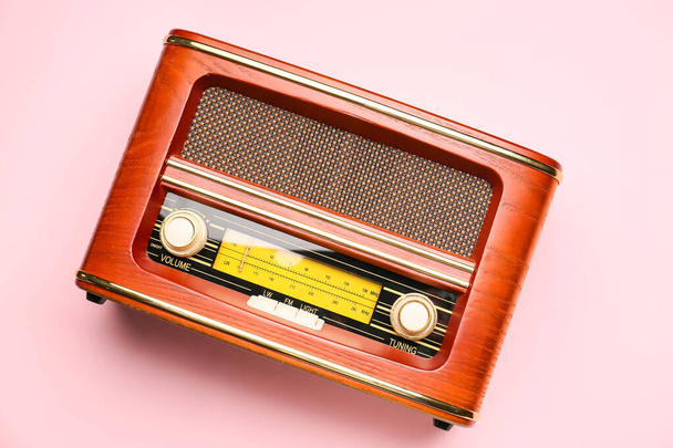 Vintage radio receiver on color background - Φωτογραφία, εικόνα