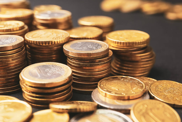 Heap of golden coins on dark background, closeup - Фото, зображення