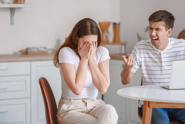 Mladý muž křičí na svou přítelkyni v kuchyni - Fotografie, Obrázek