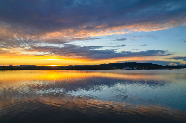 Sunrise, cloud and reflections at Woy Woy Waterfront on the Central Coast, NSW, Australia. - Фото, изображение