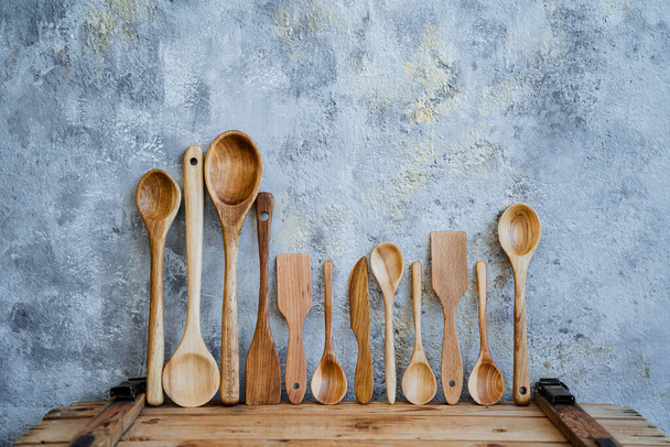 wooden spoon. a set of table items made of wood. carpenter cut spoons out of wood, handmade by the master carpenter. Kitchenware. High quality photo - Foto, imagen