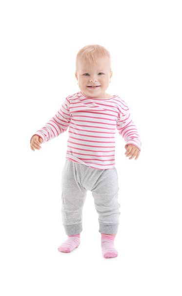 Cute baby girl learning to walk on white background - Foto, Imagen