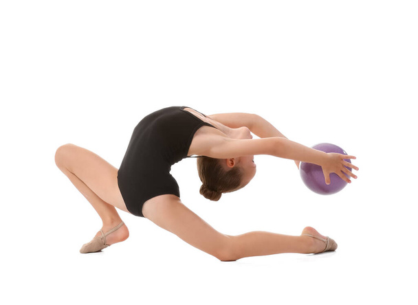 Little girl doing gymnastics with ball on white background - Foto, imagen