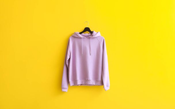 Μοντέρνο hoodie κρέμεται στον τοίχο χρώμα - Φωτογραφία, εικόνα