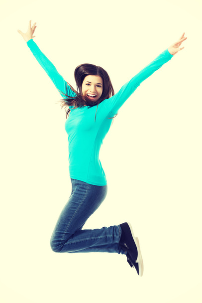 Young casual woman, student jumping. - Fotó, kép