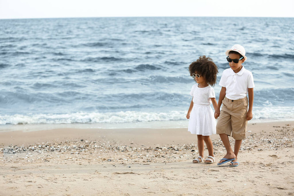 African-American brother and sister on sea beach - Photo, image