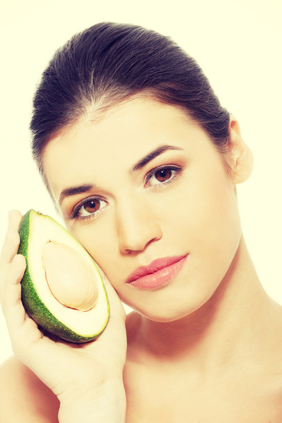 Beautiful womans face with avocado. - Foto, Imagem