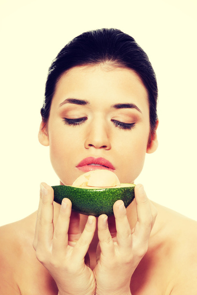 Beautiful womans face with avocado. - Zdjęcie, obraz