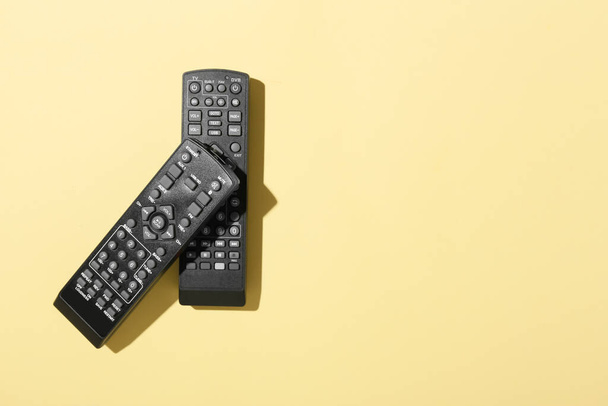 Different TV remote controllers on color background - Photo, Image