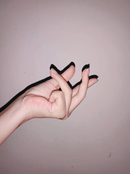hand holding a nail polish on white background - Fotoğraf, Görsel