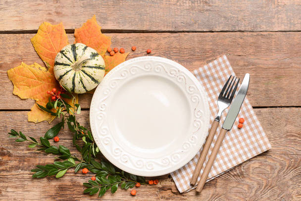 Composition with table setting and pumpkin on wooden background - Photo, Image