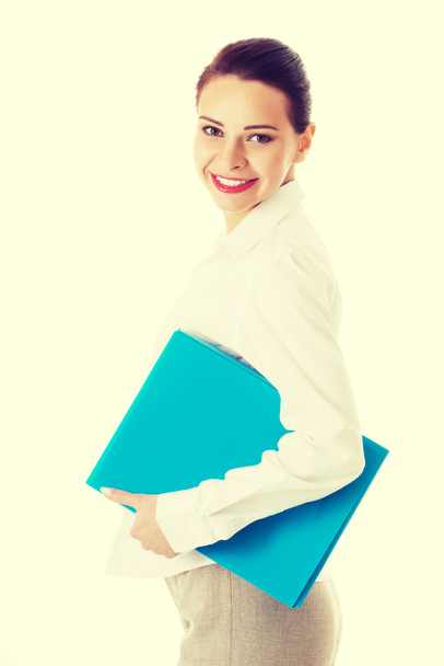 beautiful business woman holding file. - Foto, afbeelding