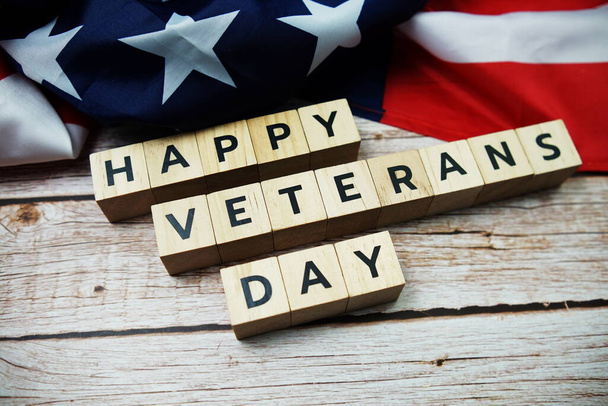 Happy Veterans Day alphabet letter and American flag on wooden background - Fotografie, Obrázek
