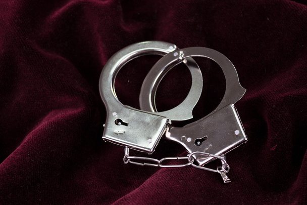 Closeup shot of metallic handcuffs - Fotoğraf, Görsel