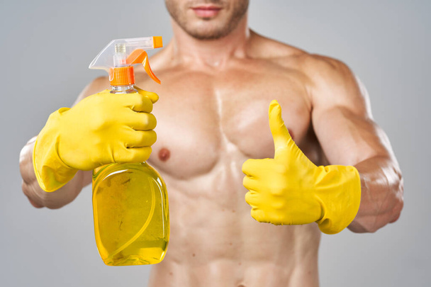 funny pumped up man rubber gloves detergents service - Zdjęcie, obraz