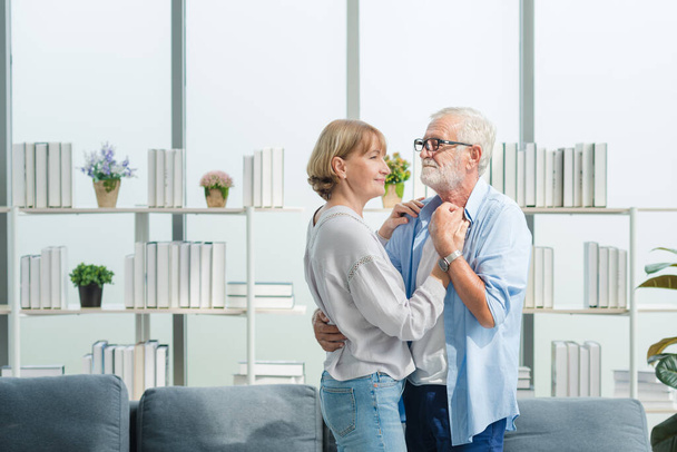 Elderly senior family couple in casual outfit dancing together with smile happy and romantic emotion in living room. - Photo, Image