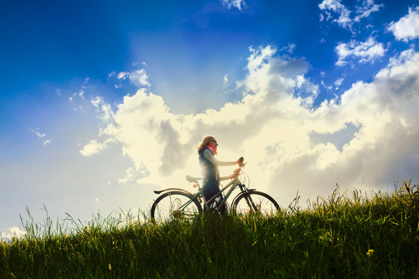 Girl with bike over sky - Photo, Image