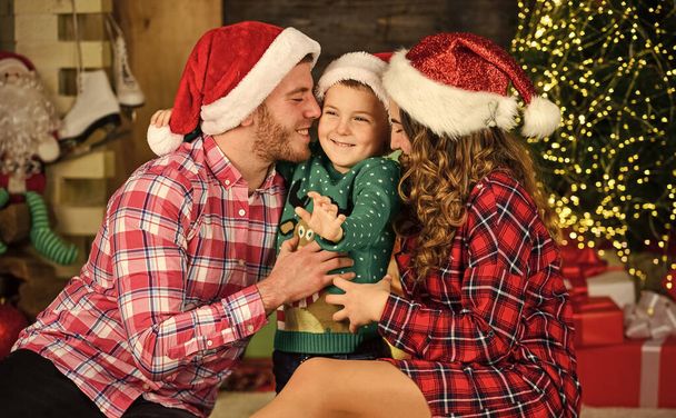Parents and child christmas eve. Parenthood happiness. Happy holidays. Christmas tradition. Father mother cute son christmas tree background. Idyllic moment. Family values. Spend time with family - Photo, image