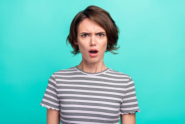 Photo of young girl unhappy sad negative angry amazed fake novelty news isolated over teal color background. - Foto, imagen