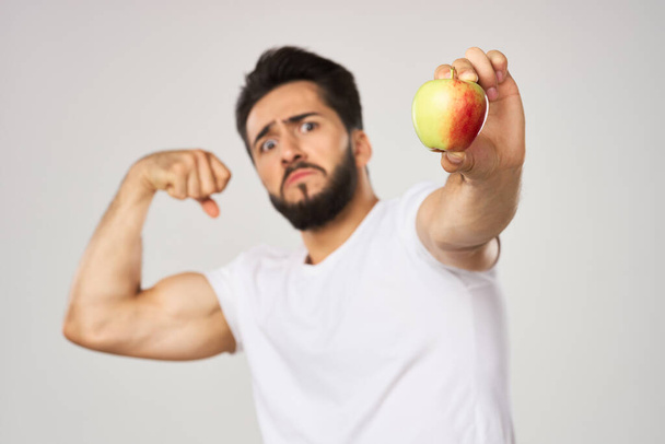 bearded man in white t-shirt apple health proper nutrition - Valokuva, kuva