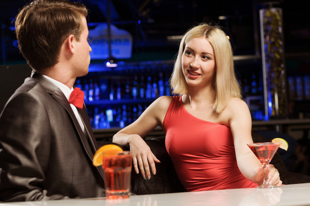 Elegant man and woman in bar - 写真・画像