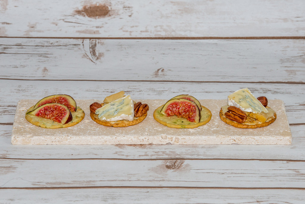 Cheese and figs on crackers - Photo, Image