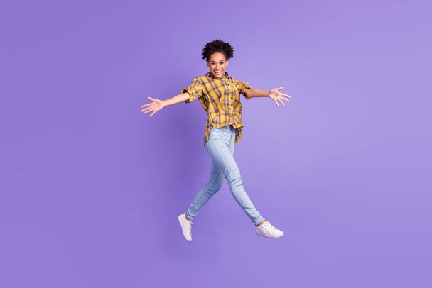 Full length profile side photo of young afro girl happy positive smile open arms hug jump isolated over purple color background. - Foto, imagen