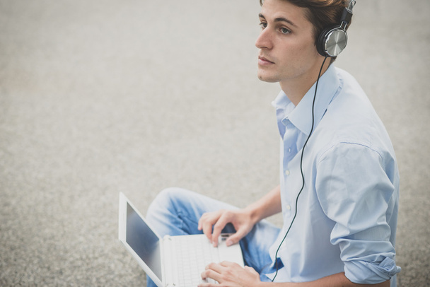 young model hansome blonde man with notebook and headphones - Φωτογραφία, εικόνα