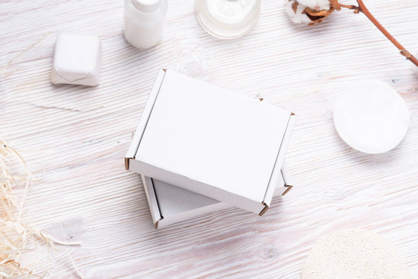 White cardboard, carton boxes on wooden table, for cosmetic smal - Valokuva, kuva