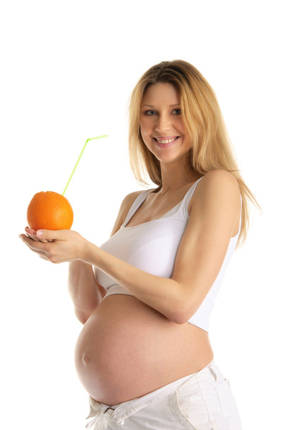 Pregnant woman holding orange with straw - 写真・画像