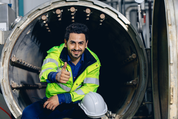 portrait engineer worker happy smiling working in factory sitting relax thumbs up - Fotoğraf, Görsel