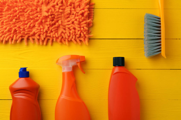 Cleaning tools composition flat lay on yellow wooden background - Foto, Imagem