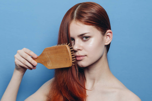 pretty woman combing hair bare shoulders hair care - Фото, изображение