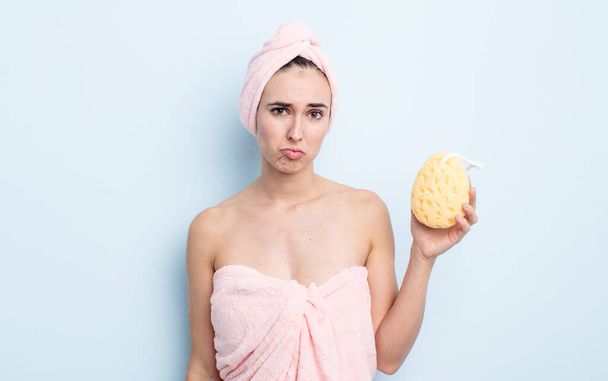 young pretty woman feeling sad and whiney with an unhappy look and crying. shower and sponge concept - Foto, Imagem