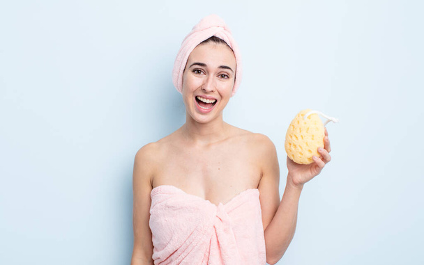 young pretty woman looking happy and pleasantly surprised. shower and sponge concept - Zdjęcie, obraz