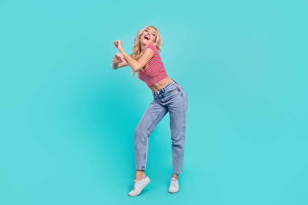 Full size photo of cheerful cool young woman funky dance enjoy weekend isolated on teal color background. - Fotoğraf, Görsel