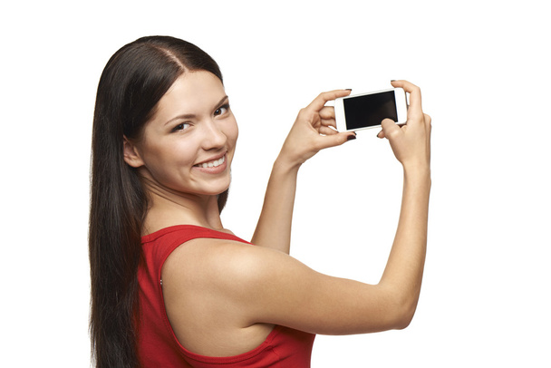 Woman taking pictures through cell phone - Foto, afbeelding