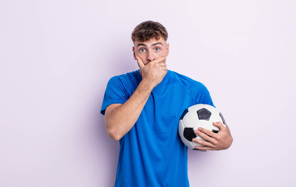 young handsome man covering mouth with hands with a shocked. soccer concept - Fotografie, Obrázek
