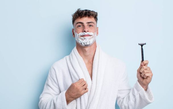 young handsome man looking arrogant, successful, positive and proud. shaving concept - Фото, зображення