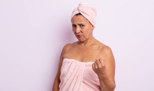 pretty middle age woman feeling angry, annoyed, rebellious and aggressive. beauty and shower concept - Фото, изображение