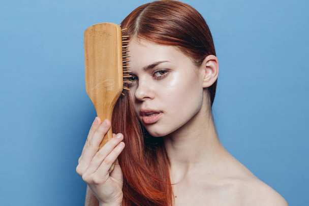 pretty woman combing hair bare shoulders hair care - Foto, imagen