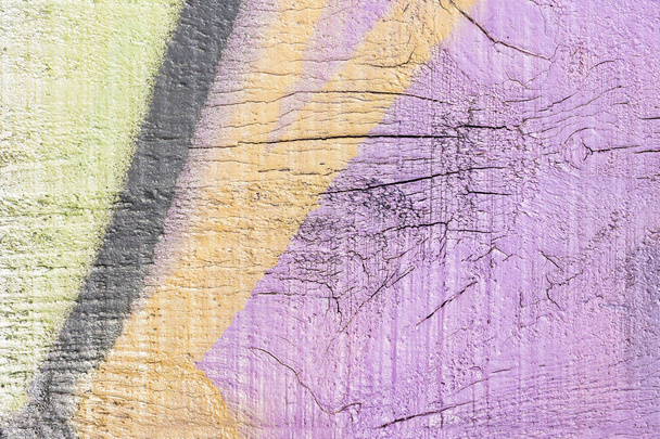 A fragment of colorful graffiti painted on a wall. Abstract urban background for design. - Photo, image