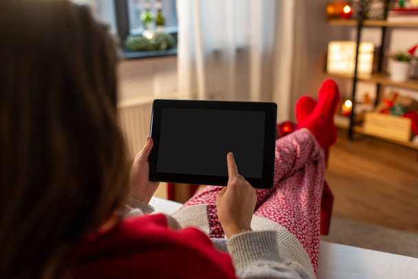 woman with tablet computer at home on christmas - Fotó, kép