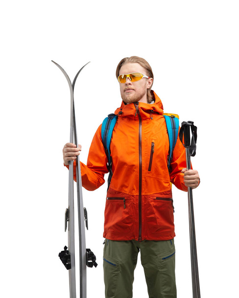 Tourist skier - with ski and touristic equipment ( clothes ), autumn - winter season, on white background, isolated. Travel and vacation concept - Foto, imagen