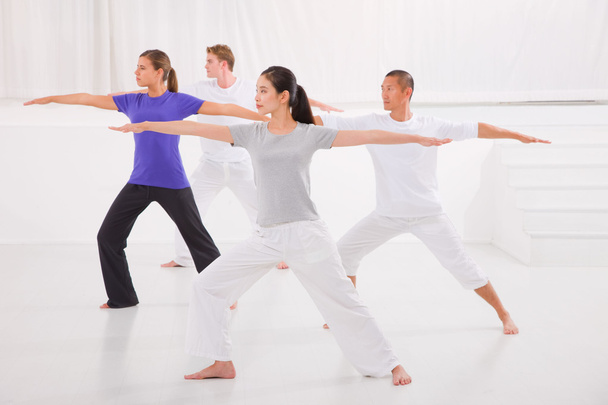 Sporty people stretching hands yoga class in fitness studio - Foto, imagen