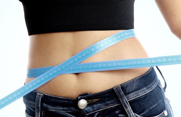 Measure tape around slim beautiful waist. - Foto, Bild
